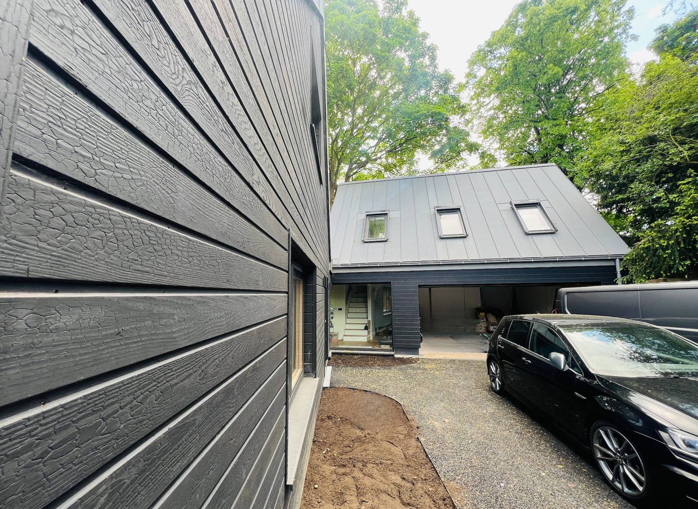 Clad home and studio with standing-seam roof