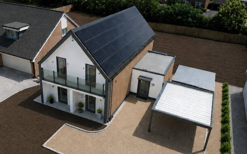 Aerial view of the completed Wunderhaus with its full solar roof and balcony