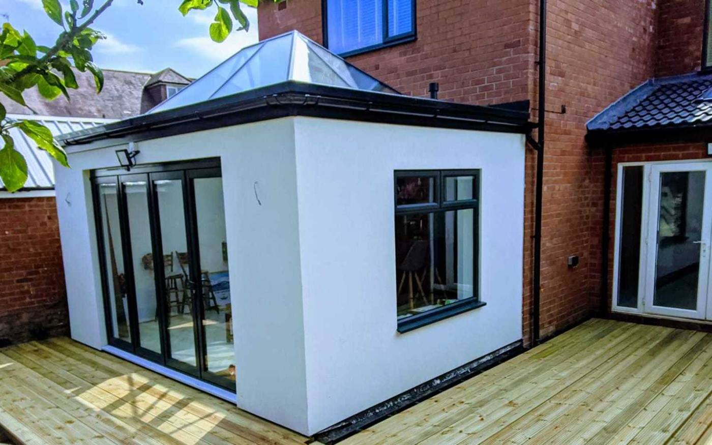 Rendered rear extension with bifold doors